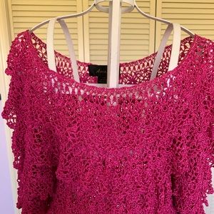 A  beautiful crochet Peasant top in a size medium. The fuchsia color